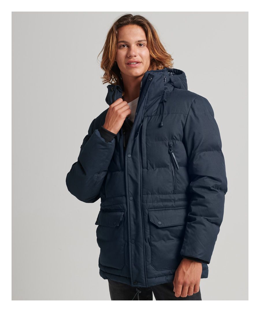 Be prepared for the colder weather with the Microfibre Expedition Parka coat. This coat features a removable hood, a nine pocket design; including an inner pocket, ribbed cuffs, and recycled padding.Relaxed fit – the classic Superdry fit. Not too slim, not too loose, just right. Go for your normal sizeButton and zip fasteningNine pocket designRemovable hoodRibbed cuffsBungee cord adjustersSignature logo badgeThe padding in this jacket is made using up to 100% recycled materials.Each jacket contains between 5 and 48 recycled bottles, depending on the weight and amount of fill used, saving waste being sent to landfill or polluting our oceans. 