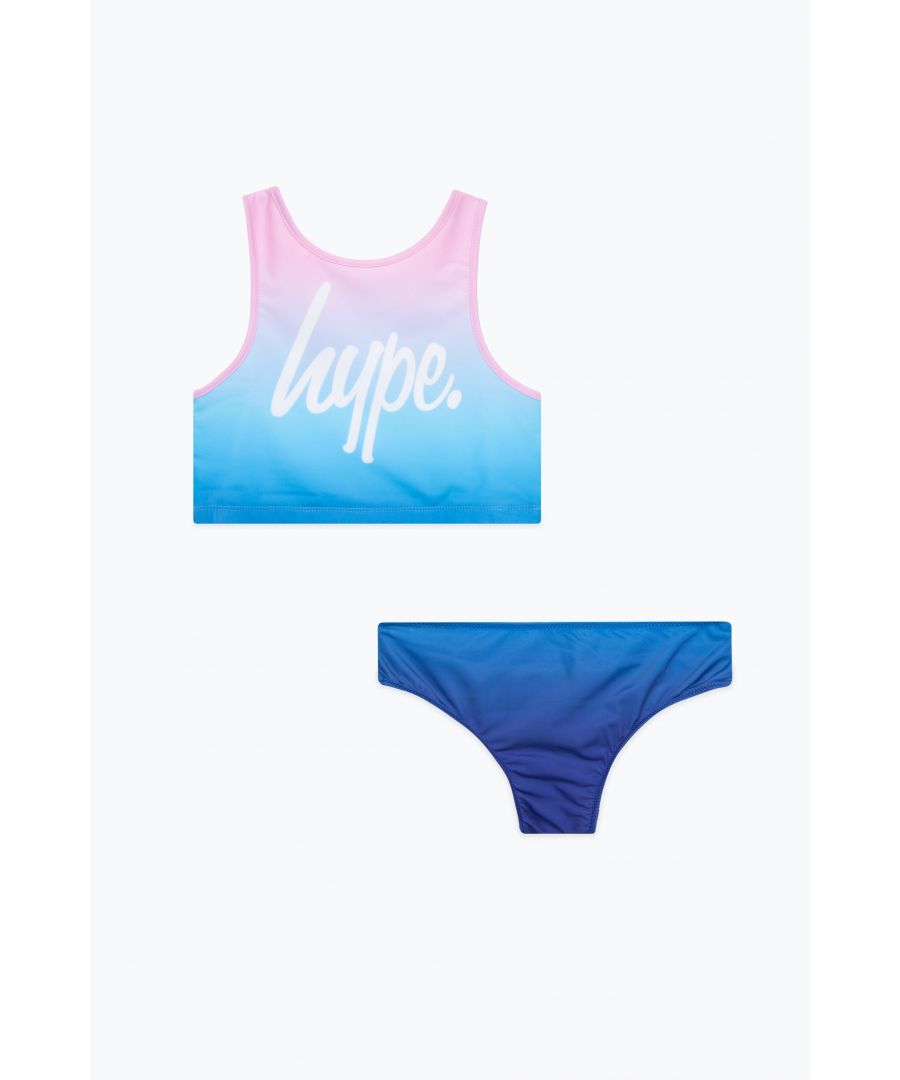 Swim is in. Meet the HYPE. Girls Pink to Blue Fade Script 2 Piece, the ultimate girls swimsuit you'll want to wear everyday of summer, autumn, winter and spring. Featuring a vest top in a pink to blue fade and dark blue bottoms in a 80% Poly 20% Elastane blend for ultimate comfort and the HYPE. script logo in contrasting white. Wear with HYPE. sliders, swimming goggles and a beach towel in hand. Machine wash at 30 degrees.