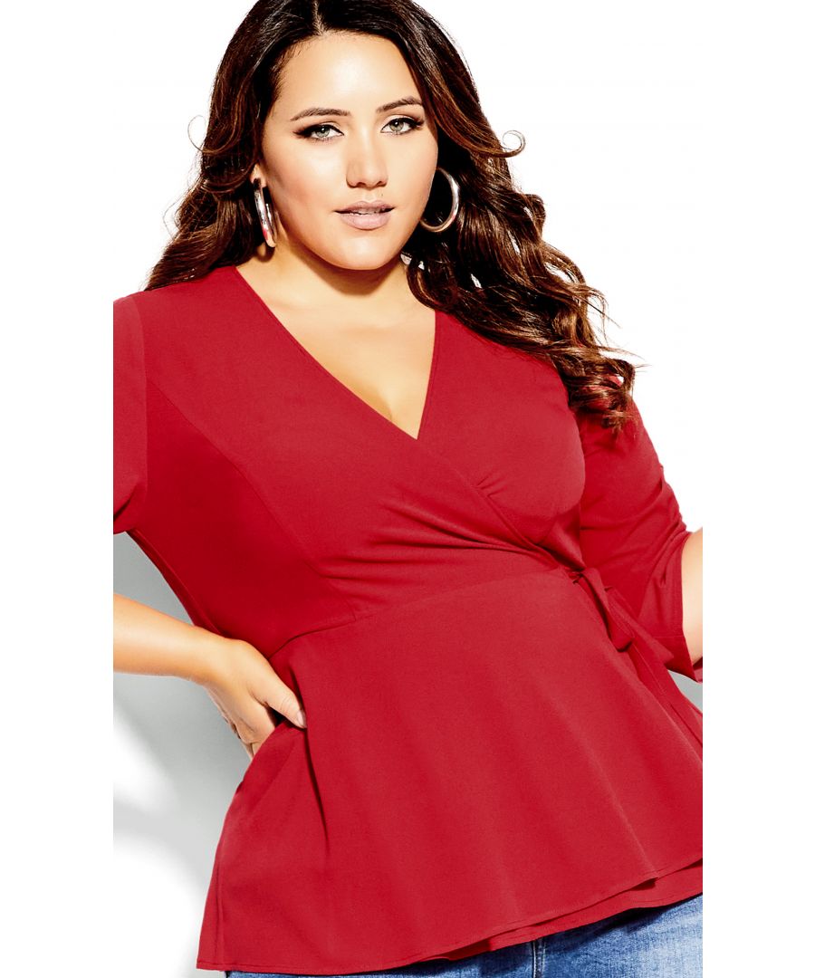 Get all wrapped up in love with the Wrap Lust Top! Featuring a lust-worthy red hue, this top includes a true-wrap silhouette with a deep V-neckline, elbow-length sleeves and a cinched waist for a form-flattering look. Key Features Include: -  Deep V-neckline -  True wrap style -  Elbow-length sleeves with adjustable tie to cuff -  Cinched waist -  Unlined Team this top with a pair of black skinny jeans and a statement necklace for an on-trend combo.