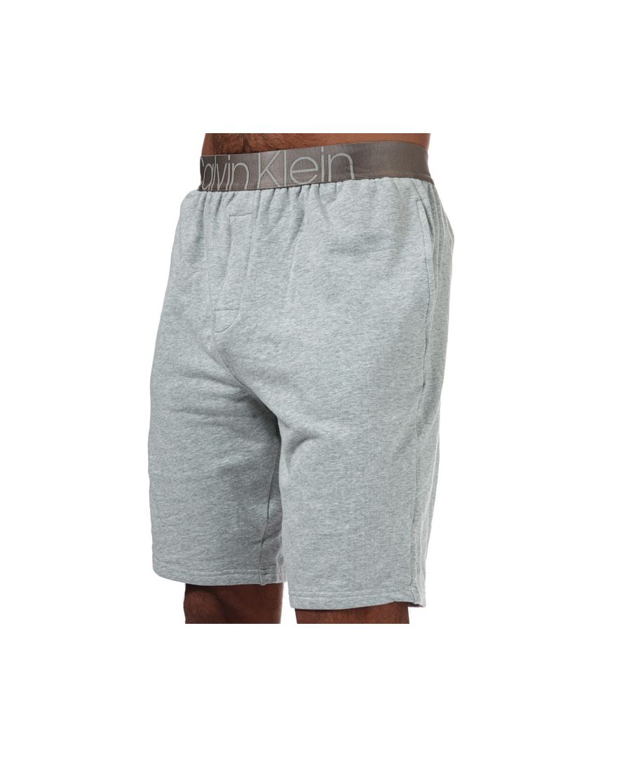 Mens Calvin Klein Icon Pyjama Shorts in grey heather.- Elastic waist is adorned with Calvin Klein's logo.- Wide elastic at the waist.- Open pockets.- Embroidered logo on back.- Main material: 95% Cotton  5% Elastane. Machine washable.- Ref: 000NM1990EPGK