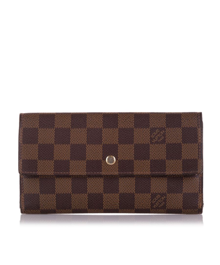 VINTAGE. RRP AS NEW. The Sarah long wallet features a damier ebene canvas body, a top flap with snap button closure, and interior zip and slip compartments.Exterior Bottom Worn. Exterior Corners Split, Worn. \n\nDimensions:\nLength 10cm\nWidth 20cm\nDepth 1cm\n\nOriginal Accessories: Dust Bag, Dust Bag\n\nSerial Number: TH0018\nColor: Brown\nMaterial: Canvas x Damier Canvas\nCountry of Origin: France\nBoutique Reference: SSU195563K1342\n\n\nProduct Rating: VeryGoodCondition\n\nCertificate of Authenticity is available upon request with no extra fee required. Please contact our customer service team.