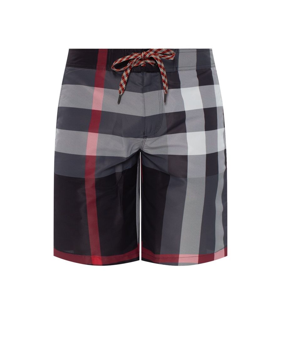 Black, white and red swim shorts from Burberry. Zip and drawstring fastening. Decorated with the brand’s signature check. Two slip pockets on the front, flap pocket with velcro fastening at the back.