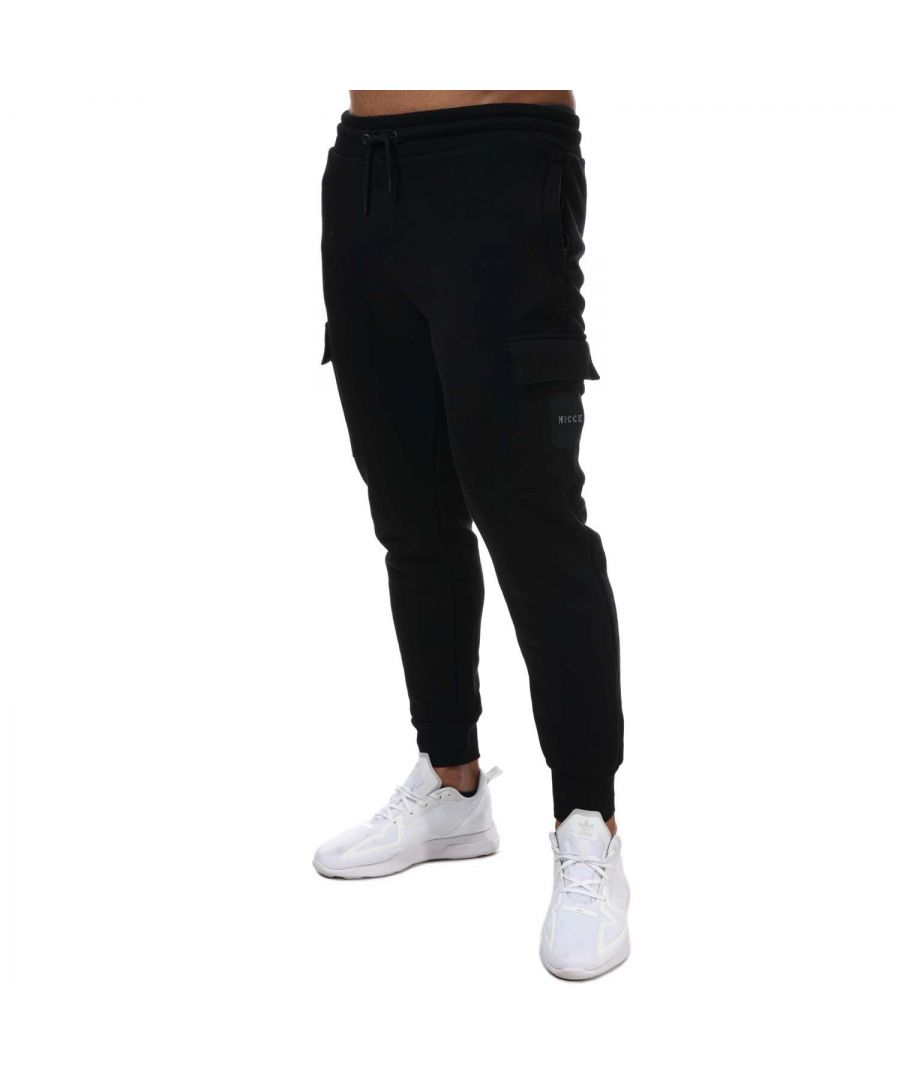 Mens NICCE Tetrad Jog Pant in black.- Adjustable drawstring waist.- Two side zipped pockets.- Side pockets.- Ankle cuffs.- Raised NICCE logo.- Tapered leg.- 60% Cotton  40% Polyester. Machine washable.- Ref: 0141K0080001