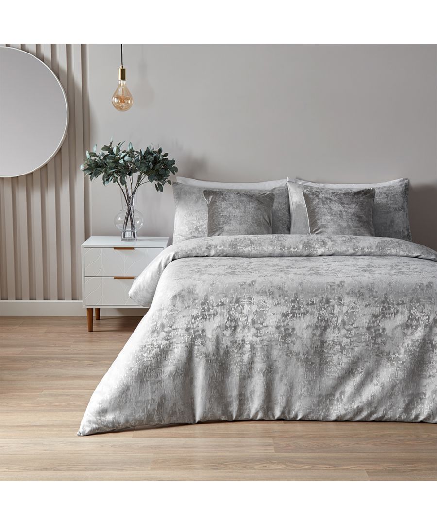 Featuring a subtle metallic jacquard design with a matching reverse. Made of a 100% Jacquard Polyester, reverse is a crisp polycotton making this duvet set is soft and hard-wearing. Clear button closure for easy removal of duvet. Includes two matching pillowcases measuring 50 x 75cm (20