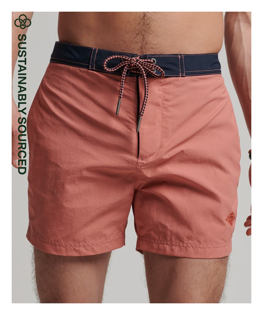 Holidays are all about making memories and having adventures. To get the most out of those warm days on the beach, it's important to dress comfortably in a way that compliments your personal style. These shorts feature great coverage both inside and out thanks to the mesh lining and are sturdy without sacrificing softness, ensuring that you can rock them all day long for those sunny days in or out of the water.Relaxed fit – the classic Superdry fit. Not too slim, not too loose, just right. Go for your normal sizeHook & loop and drawcord fasteningTwo side pocketsHoop and loop back pocketEmbroidered patchMesh liningRecycled contentsEmbroidered Superdry logoBy 2050, there will be more plastic in the ocean than fish.Help save plastic from polluting the earth. Wear this instead.This new swimwear fabric is made from 100% recycled post-consumer waste.#GrowFutureThinkingPlease note due to hygiene reasons, we are unable to offer an exchange or refund on swimwear unless they are sealed in their original packaging. This does not affect your statutory rights.