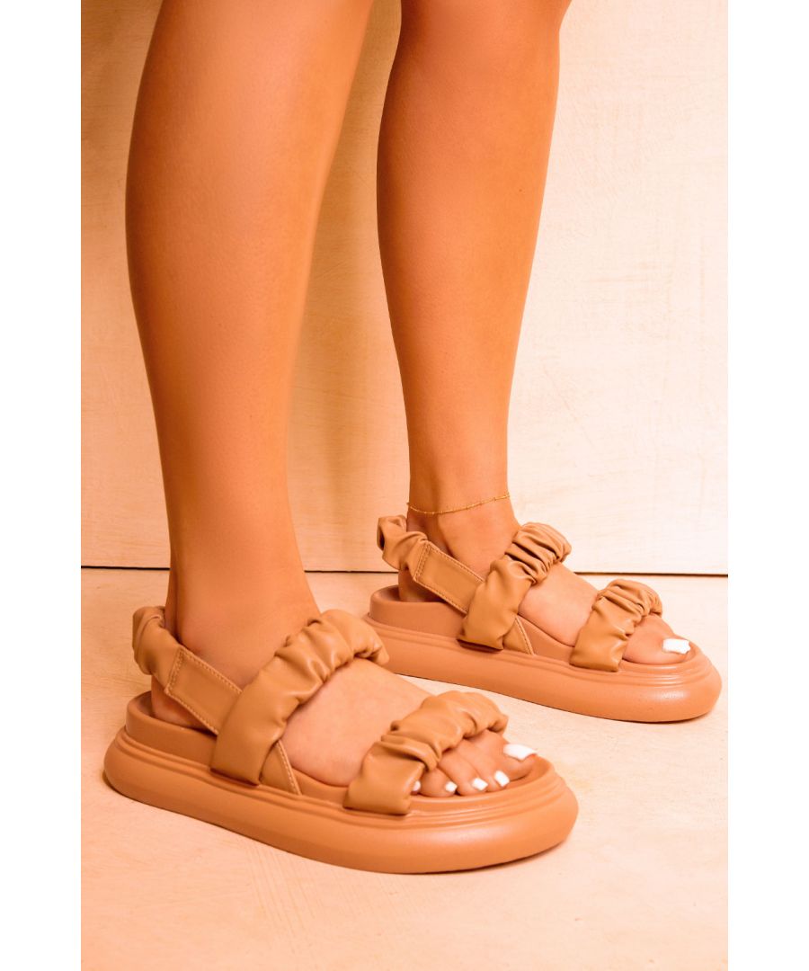 Women’s flat sandals featuring ruched multistraps with a chunky sole.