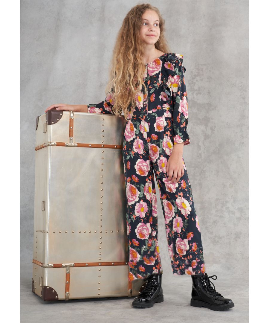 Elevate your style in this wide leg floral jumpsuit. Beautiful oversize blooms with over the shoulder ruffles  button front and back elsticated waist make it super easy to wear.  Angel & Rocket cares – made with recycled polyester  Colour - Navy / Multi  About me: 100% polyester  Look after me – Think planet  wash at 30c