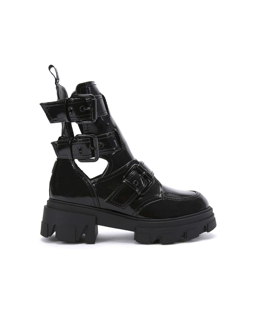 The Trekker Buckle ankle boot features a black patent upper with three black buckled straps. There is a KG Kurt Geiger stitched branded tab as well as black rubber branded monocle on the back of the ankle. Heel height: 6cm. This product contains a unique KG Kurt Geiger branded outsole design that has been created specifically for this style. This product is registered with The Vegan Society.