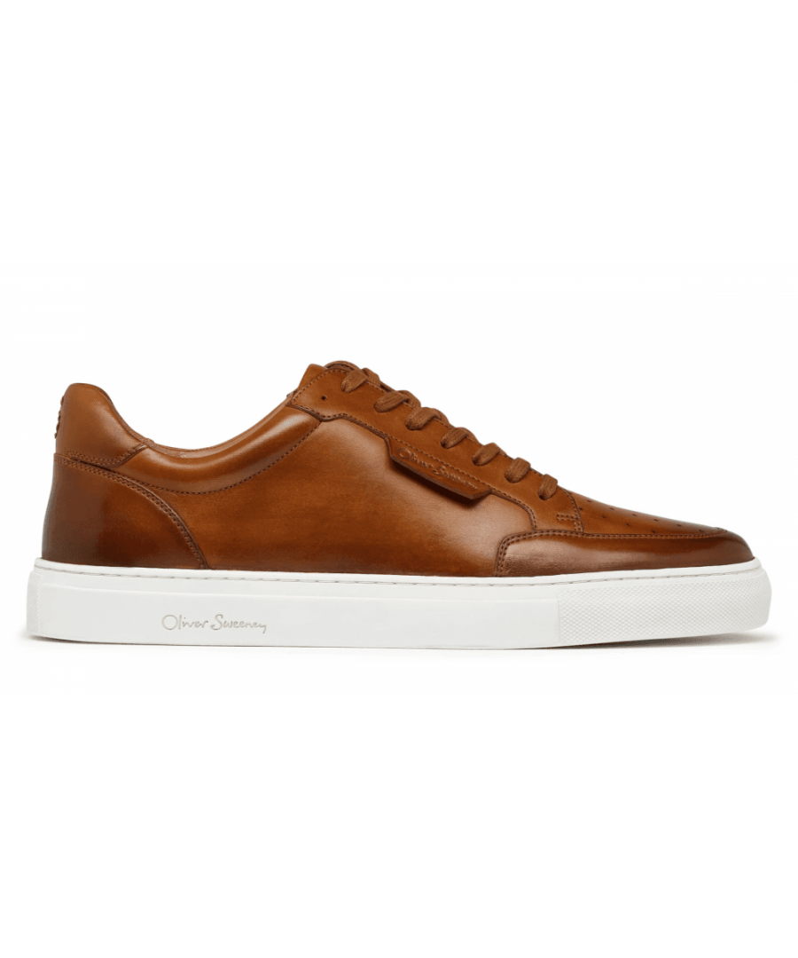 The new Edwalton is made from a fine tan calf leather, antique finished by hand. It includes a ¾ leather lining and full leather insock. The upper design is a classic court shoe pattern with reinforcement around the toe, a padded collar, punch detail on the front and a subtly branded, embossed side tab. Made in the traditional way, the trainers are cemented to a cupsole and secured with a side stitch.\nAntiqued leather upperLeather liningRubber cupsolePerforated toe detailBranded tab\nMade in India\n 