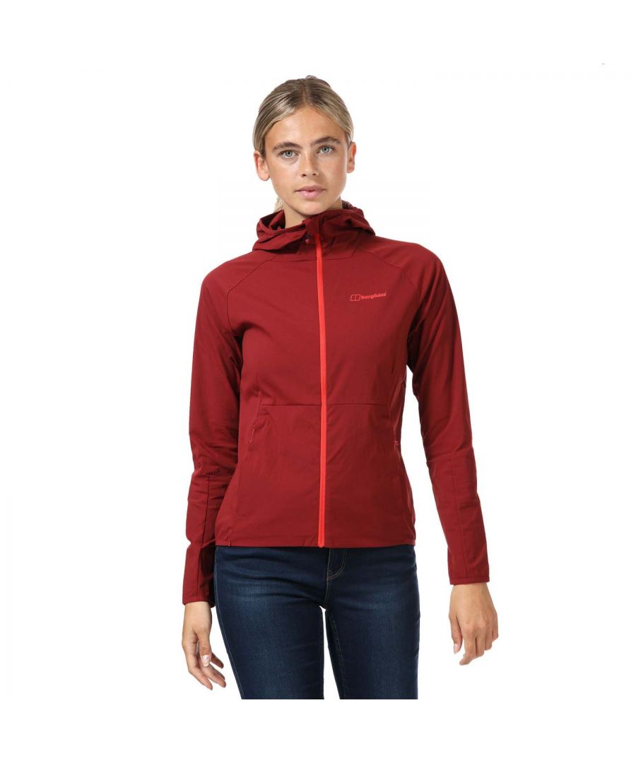 Womens Berghaus Arrina Hooded Stretch Woven Jacket in dark red. Lightweight woven jacket in a flattering and comfortable stretch fabric.- bluesign® approved main fabric with a PFC-free DWR (durable water repellent) finish for great performance and sustainability.- Fixed hood with stretch binding trim.- Full zip fastening with chin guard.- Long sleeves with stretch binding at cuffs.- Zipped pockets to front. - Stretch binding trim at rear hem.- Berghaus logo printed at left chest.- Body: 95% Polyamide  5% Elastane. - Ref: 4-A001061X60