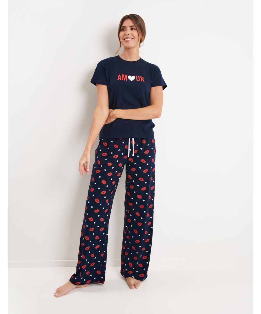 This adorable pyjama set from Threadbare features a short sleeve top and wide-leg bottoms. Made from super soft cotton for a comfortable feel and easy washing. The top has a front print and the wide leg bottoms features an all-over print and elasticated waistband with contrasting drawcord. Other styles are available.