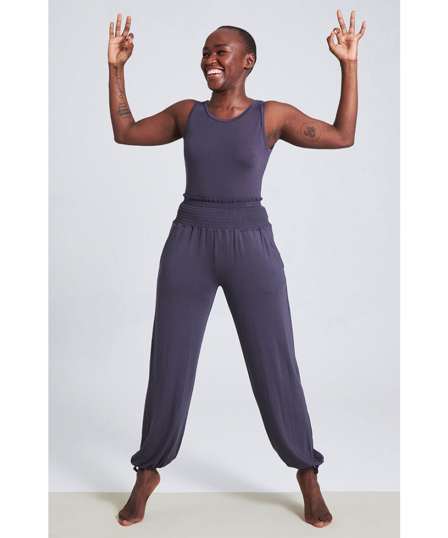 These bamboo pants are truly dreamy. The deign makes them as comfy to wear as they are flattering. Ideal for your softer yoga practice and I-don't-want-to-get-off-the-sofa days.\n\nWide smocking waist detail\nSelf tie hem detail\nPerfect for inversions won't ride up\nMade with 95% Bamboo Viscose, 5% Elastane\nUnrivalled softness and great for sensitive skin\nNaturally sweat-wicking and breathable\nFrom sustainably managed forests\nOeko-Tex certified no nasties in the dyeing process\n\nApprox inside leg measurements:\nXS to XXL - 73cms / 29