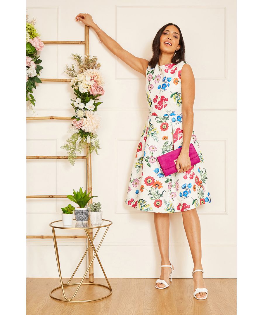The summer is here and so is this Yumi Floral Jacquard Dress. Adorned with a vibrant display of floral blooms, this fit and flare dress offers a feminine silhouette with the structured pleats. The jacquard feel lends an elegant edge, complemented by the heavyweight fabric and fitted bodice. A zip glides up the back to finish.