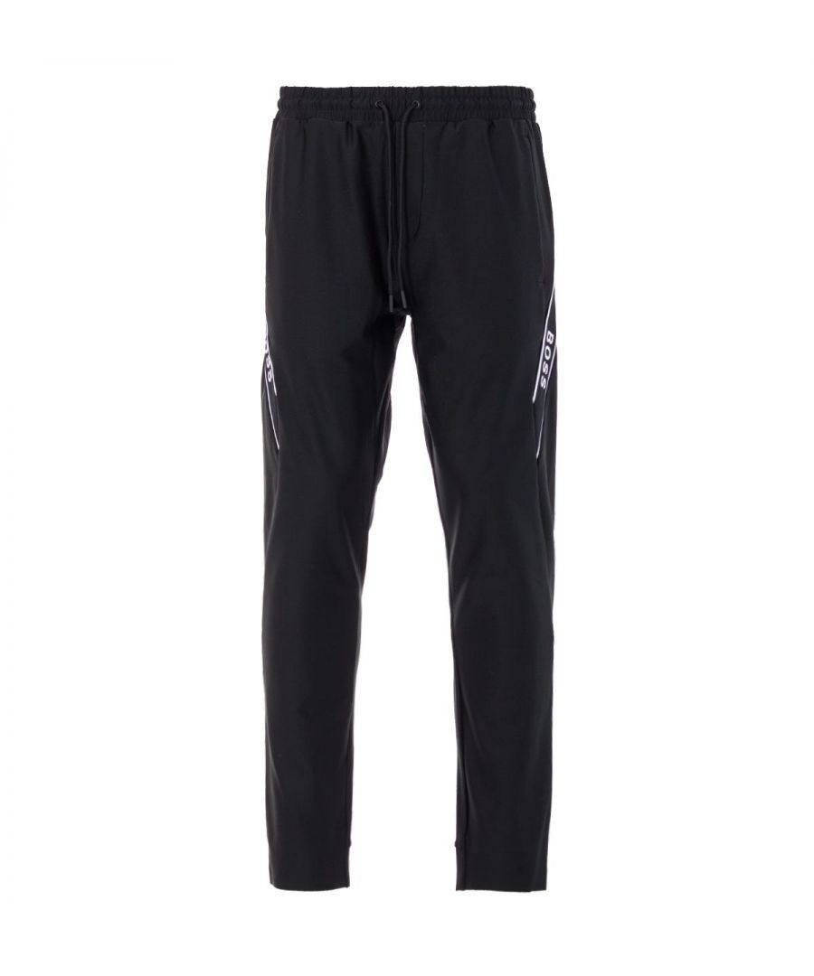 Crafted from an innovative stretch fabric composed of recycled polyester, these versatile tracksuit joggers from BOSS boasts dynamic cutlines outlined by contrasting logo tape for statement style. Cut to a slim fit creating a modern silhouette and features an adjustable drawstring waist, side seam pockets and a rear zip pocket. Perfect for a modern sport look.Slim Fit, Stretch Recycled Polyester, Adjustable Drawstring Waist, Side Seam Pockets, Rear Zip Pocket, Contrast Logo Tape Inserts, BOSS Branding. Style & Fit:Slim Fit, Fits True to Size. Composition & Care:87% Recycled Polyester, 13% Elastane, Machine Wash.