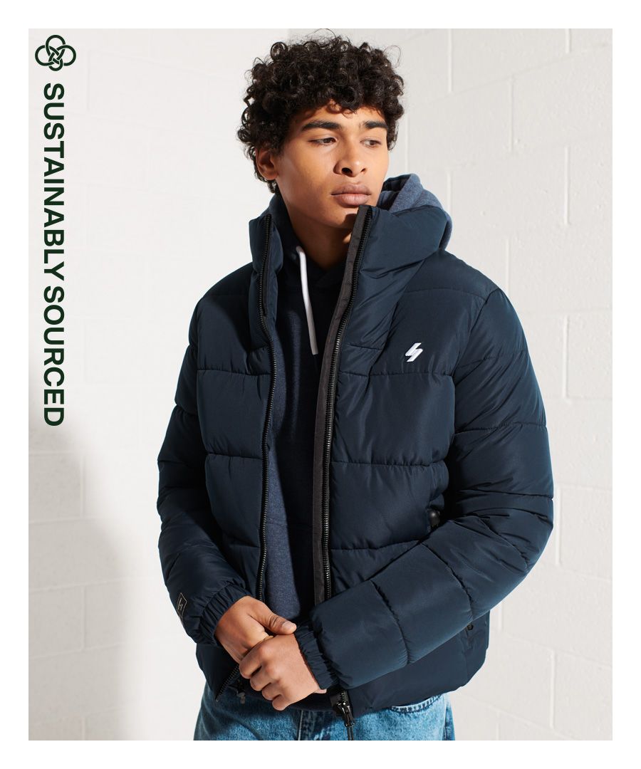 The seasons are changing, and you deserve something comfortable and stylish for them. The Non Hooded Sports Puffer Jacket will look great over your favourite layers and keep you warm whilst doing it.Relaxed fit – the classic Superdry fit. Not too slim, not too loose, just right. Go for your normal size.Recycled paddingZip fasteningTwo zipped front pocketsElasticated cuffsEmbroidered logoBungee cord adjustable hemFleece liningInternal mesh pocketSignature Superdry patchThe padding in this jacket is 100% Recycled Polyester, made from up to 10 recycled bottles, sourced from household recycling plants in China. 