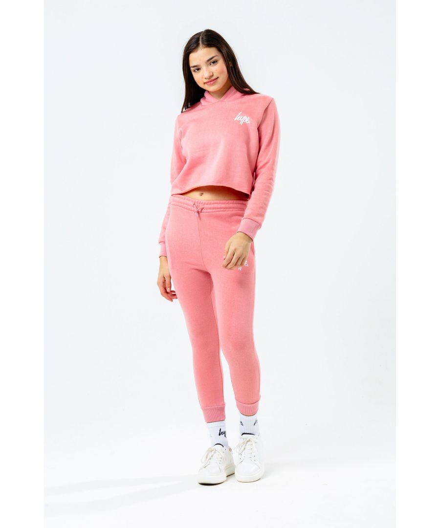 The Hype Pink Cropped Kids Hoodie and Joggers Set features the utmost supreme soft touch fabric for the ultimate comfort. This set features our standard kids crop hoodie and kids joggers in pink. The girls crop boasts a fixed hood and fitted cuffs finished with the iconic mini HYPE. script logo in a contrasting white. The girls joggers feature an elasticated waistband, fitted cuffs and drawstring pullers, finished with the iconic mini HYPE. script logo in a contrasting white. Machine washable.