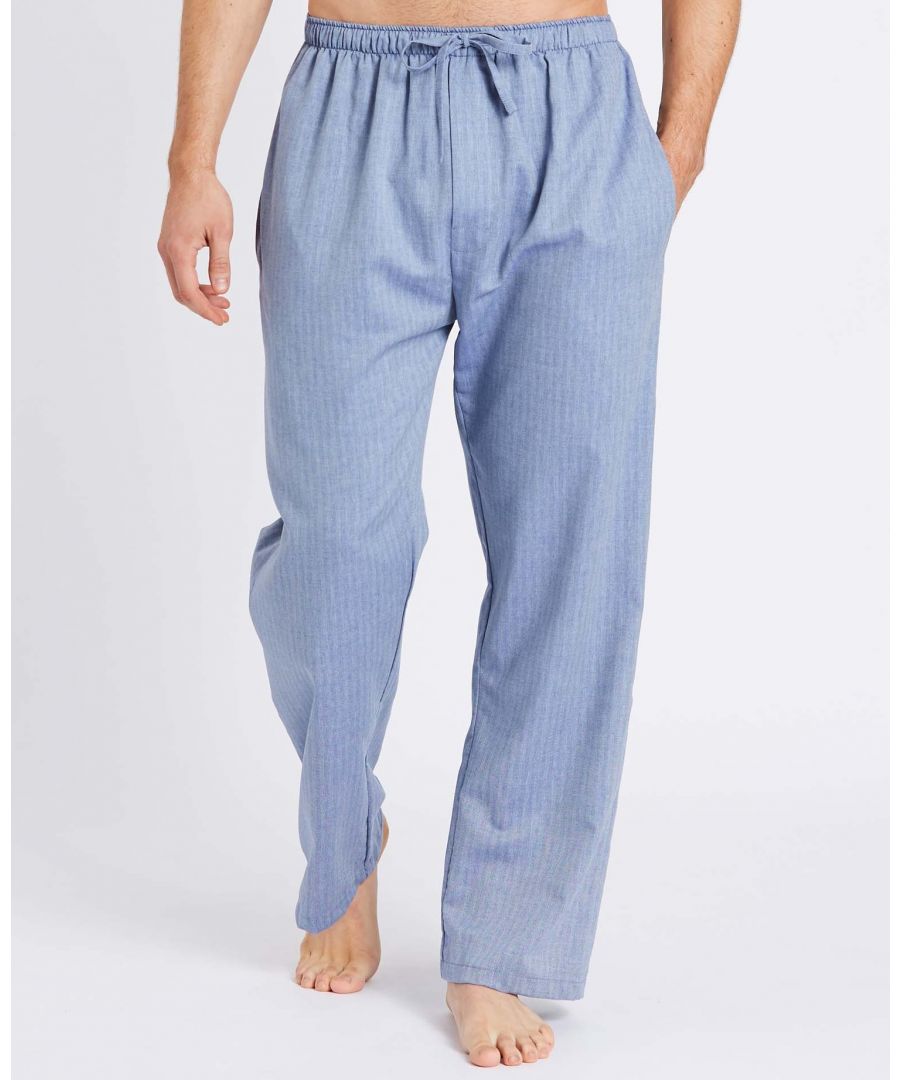 Made from the softest twill cotton in our stunning garrison blue herringbone, our signature pyjama trousers are the perfect apparel for lounging all year round because this fabric will keep you warm in winter and cool in summer. This fabric is woven into a lightweight subtle herringbone design and the fibres brushed lightly so the cloth feels wonderfully luxurious against the skin. They have a combined soft elastic and self fabric tie waist, two inset side pockets and two rear patch pockets to help keep phones and other items close to hand whilst you're relaxing. They also feature a closed fly. These look great teamed with our long sleeve white top and matching robe.