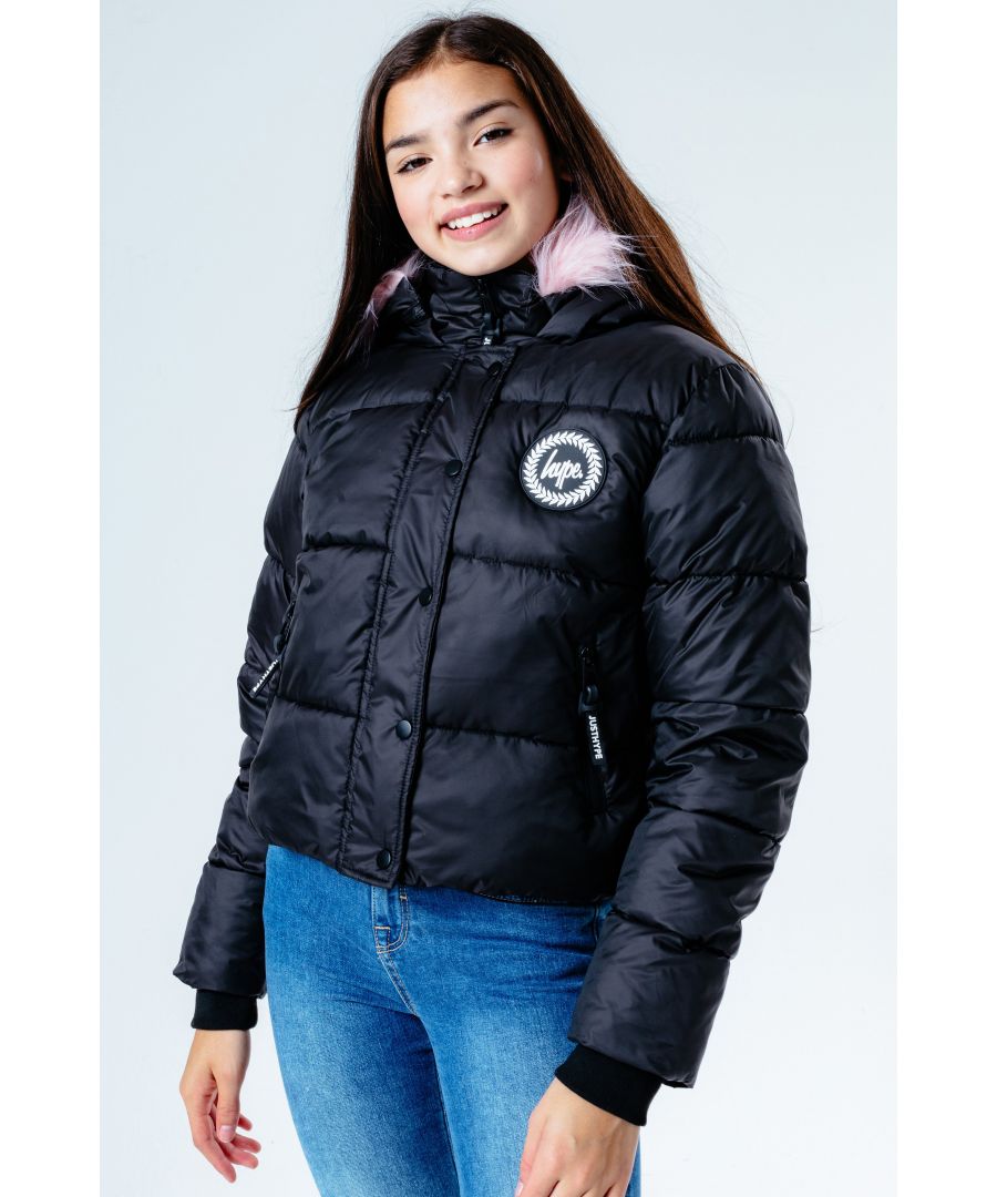 The Hype. Black Hooded Cropped Kids Puffer Jacket is the perfect kids coat you need this winter. Designed in our standard girls cropped puffer shape in a classic black, with a removable pink faux fur hood trim. Finished with the iconic HYPE. crest badge logo in a contrasting monochrome and two zip pockets on the front. Machine washable.