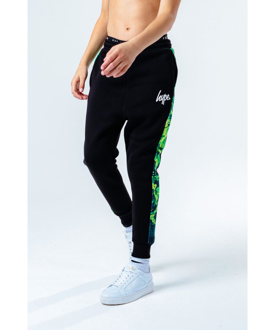 The HYPE. Green Panel Kids Joggers features an all-over black colour palette with a green injection. With on-trend leg panelling in a green abstract print finished with piping detail. In a 35% polyester and 65% cotton fabric base for supreme comfort in our standard unisex kids jogger shape, highlighting an elasticated waist, cuffs and pockets. Finished with the iconic HYPE. script logo in a contrasting white. Wear with the matching hoodie to complete the look. Machine wash at 30 degrees.