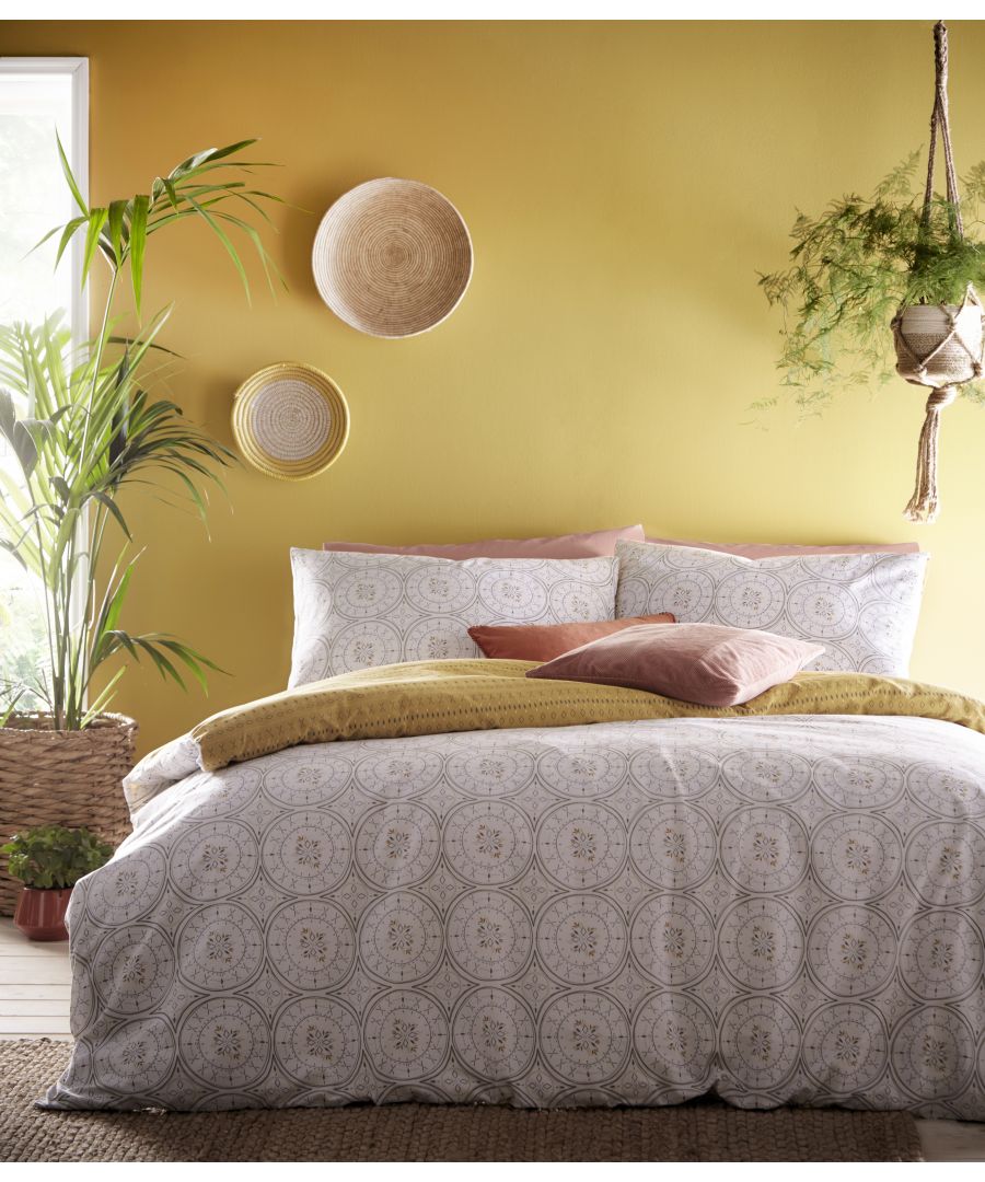 Tribal inspired shapes in different scales create this print. The continuous circular pattern is evocative of hand printed traditional global textiles. A burst of colour on the reverse really makes the design pop, and means this can be mixed with warm tonal accessories throughout the year.