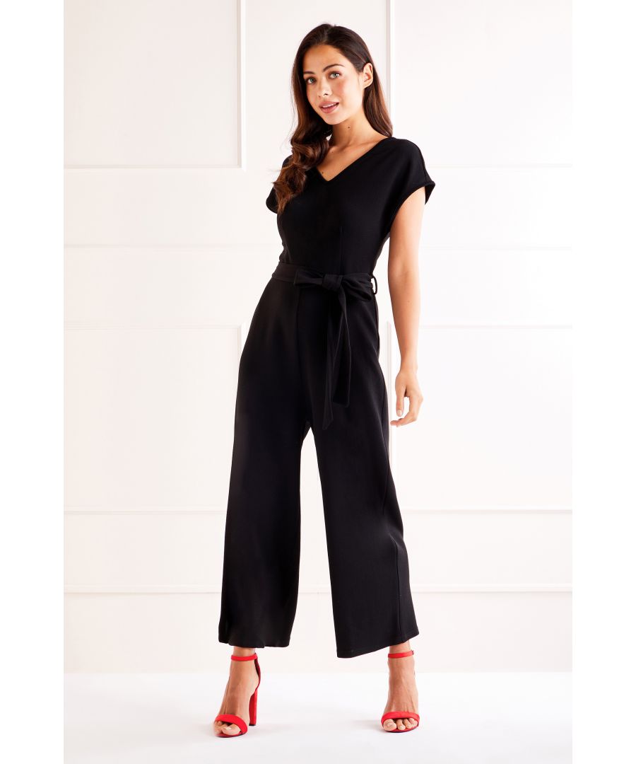 Perfect for the office or drinks with the girls, our Capped Sleeve CulotteJumpsuit is a sure fire favourite. In contemporary and always stylish black you could add a pop of fun and personality to this cropped culottes jumpsuit by adding a pair of your favorite killer heels and show a peak of your perfect pins. With a gentle and feminine v neck and belted design, alongside those flattering capped sleeves it's a real seasonal show stopper.  Shell: 95% Polyester 5% Elastane Machine Wash At 30 Length is 129cm