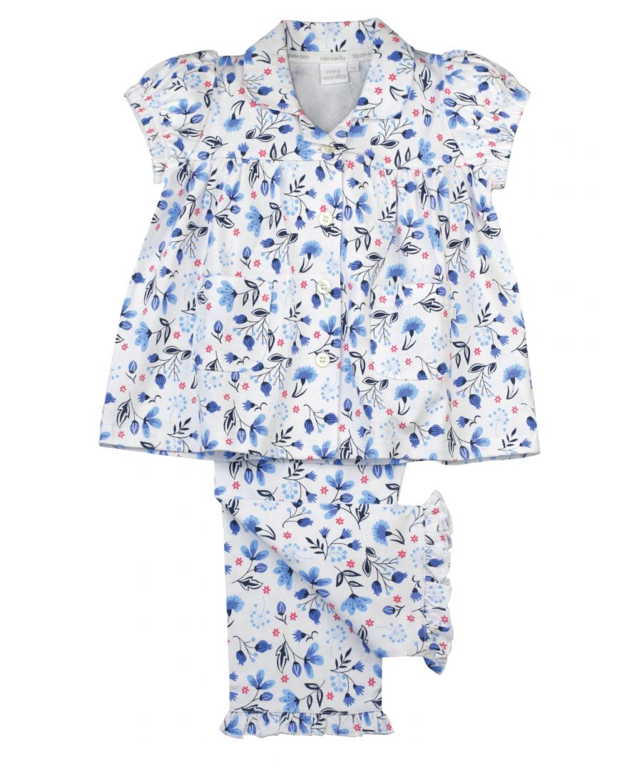 Cool, fresh blues in a ditsy floral print brings some Spring/Summer vibes to our girls jersey pyjama set. Made from super-soft 100% cotton the set is trimmed with Mini Vanilla back neck tape, revere collar and fastens at the front with Mini Vanilla engraved buttons.  Pockets too - to keep all essentials - Polly pocket, lego even night time snacks! Fully elasticated at the waist and a frilled hem make for very comfy trousers.