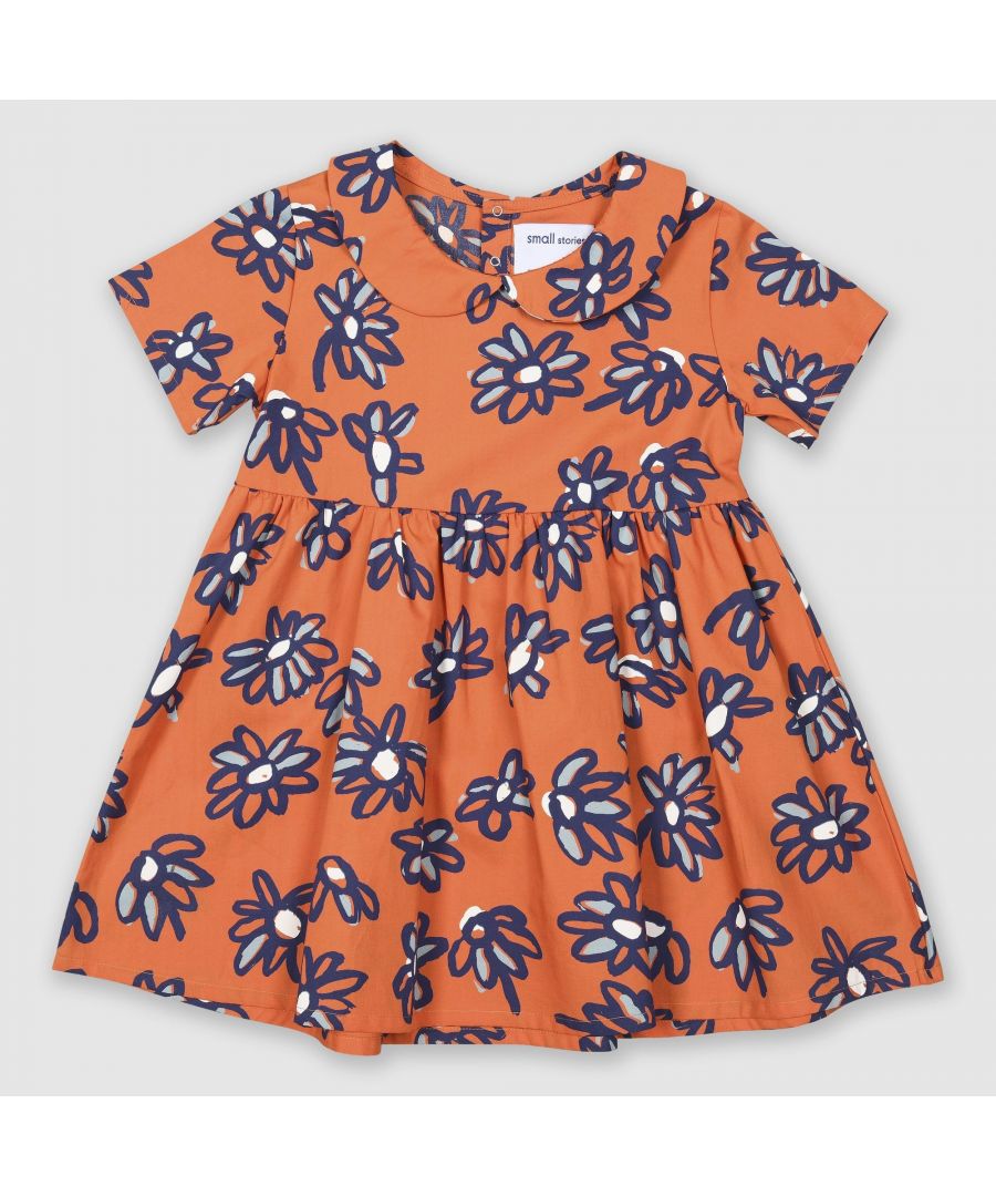 Lightweight 100% cotton dress with our bespoke painted daisy print in orange with blues and white. Features a Peter Pan Collar and press stud back opening for ease of dressing.