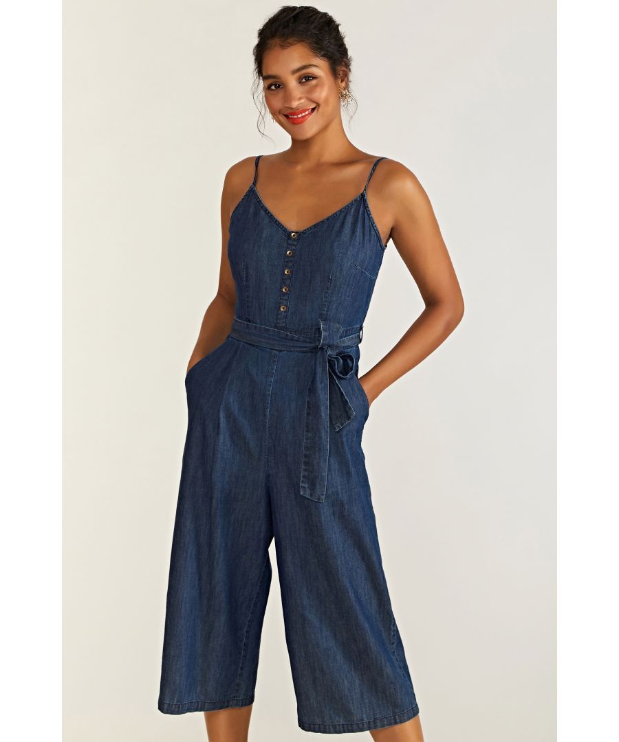 Do denim differently this season and opt for this Denim Jumpsuit With Button Detail. Falling on the knee, this casual jumpsuit features a sleeveless design and button detailing. The self-tie waist cinches your shape, while soft denim material is comfortable and figure flattering. Be bold this summer, partner this jumpsuit with statement heels and matching jewellery. 100% Cotton. Machine Wash At 30. Length is 110cm/43inches. Lilly is 5ft 9in, 180cm and wears size 10.