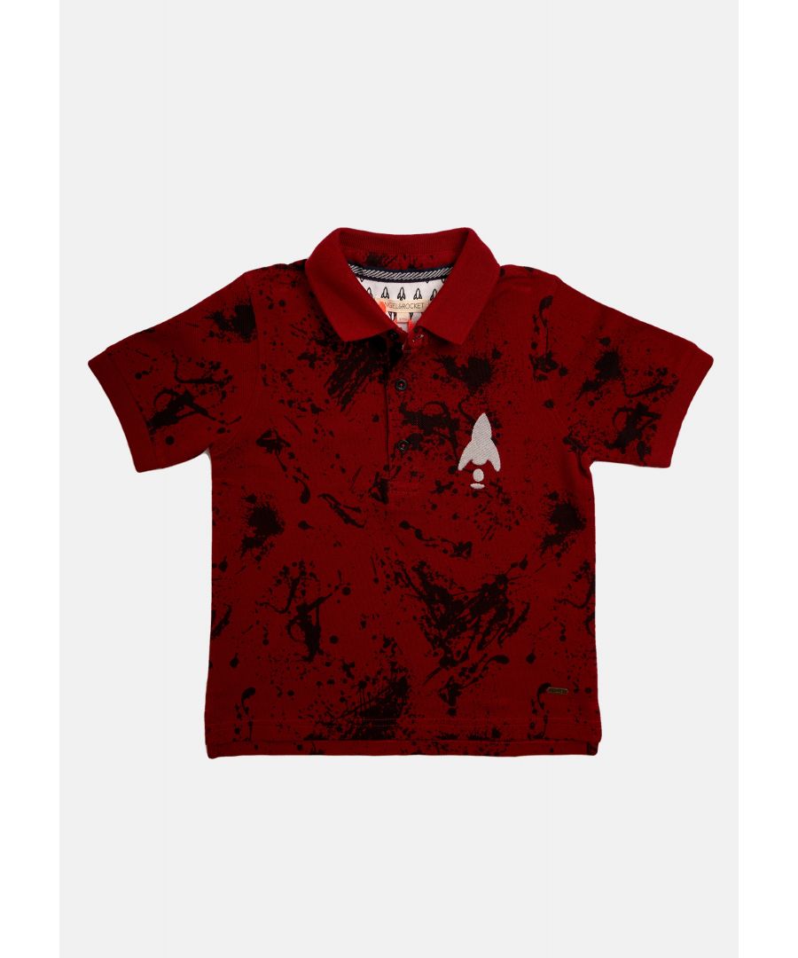 Stand out in the style department with this paint splat print polo. Red pique with navy print  flat rib collar and branded button placket. For a sharp  daytime look  team with skinny jeans and trainers.   Angel & Rocket cares - made with fairtrade cotton   Red   About me: 100% cotton   Look after me: think planet  Machine wash at 30c