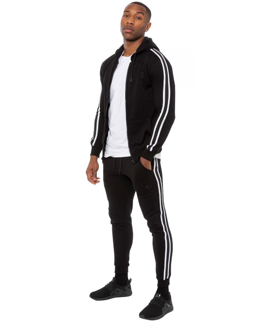 Enzo Mens Tape Hoodie Full Zip Tracksuit. Zip Through Hooded Top. Enzo Embroidery Logo on Chest and Contrast Stripe Design on Sleeves. Hoodie with Drawstring. Ribbed Waist and Cuffs. Kangaroo Pockets. Enzo Mens Casual Designer Striped Tracksuit Joggers. Featuring Classic Contrast Stripes to Sides. 2 Side Pockets. Cotton Blend for Superior Comfort. Adjustable Waist with Drawstrings. Athleisure Perfect for All Gym wear