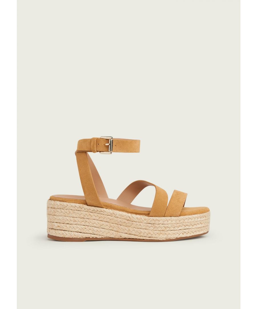 A contemporary take on the classic espadrille, our Siena sandals have a modern feel. Crafted in Spain from beautifully-soft tan suede, they have asymmetric straps, a buckled ankle strap and platform espadrille soles. Wear them on sunny days with your favourite sun dresses or shorts and tees.