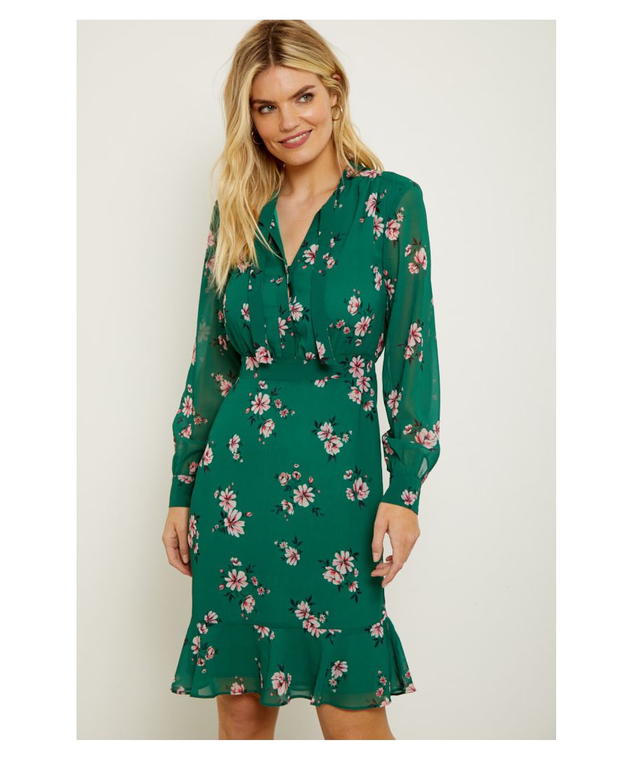REASONS TO BUY: \n\nFlowers to brighten your wardrobe - and your day\nThis dress is designed to flatter\nNeck tie, ruffle hem, blouson sleeves – it’s the little details\nFor work, date night or drinks with the girls\nToughen it up with a leather biker or style with a denim jacket\nJust add your favourite ankle boots