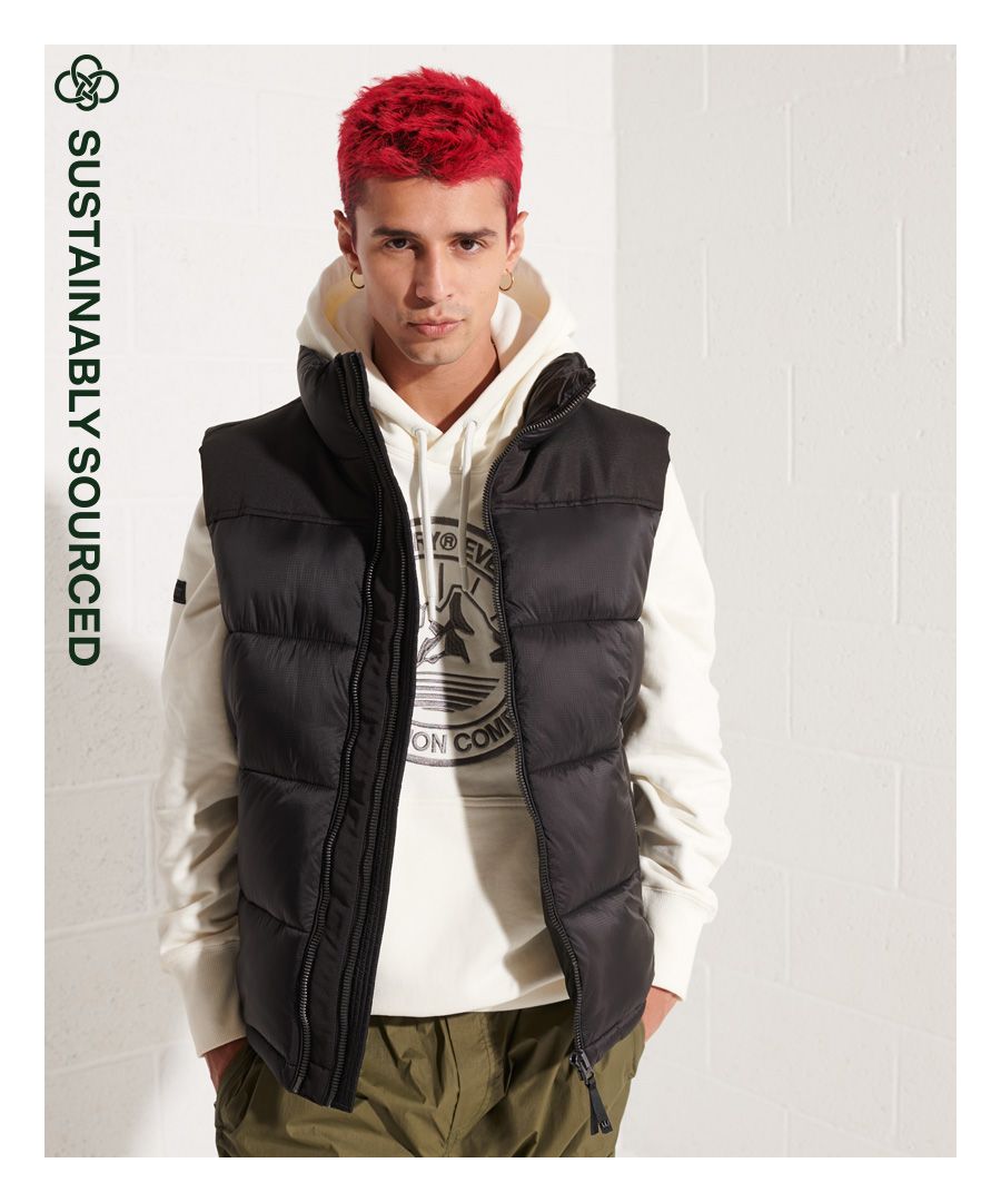 Keep yourself warm with our Padded Gilet. We've taken a classic gilet and given it a slight twist with its dual zip fastening, allowing you to choose between a looser or more sung fit. Your comfort is now in your control.Relaxed fit – the classic Superdry fit. Not too slim, not too loose, just right. Go for your normal size.Quilted paddingTwo zip fasteningsTwo zip pocketsBungee cord hemOne internal mesh pocketMetal badgeRecycled paddingClassic Superdry tabThe padding in this jacket is 100% recycled, each jacket contains up to 30 recycled bottles, this avoids these bottles being sent to landfill or polluting our oceans.