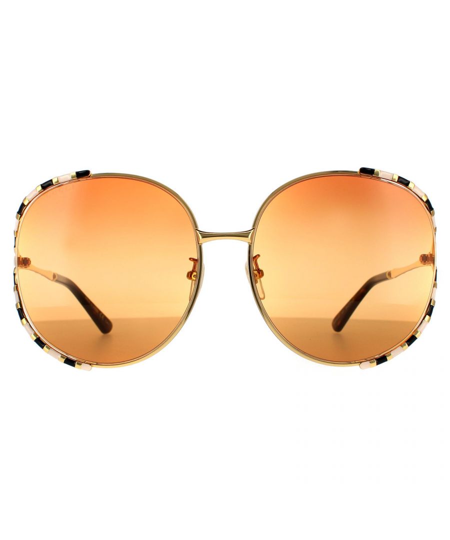 Gucci Round Womens Gold with Ivory and Black Double Orange on Brown Gradient  Sunglasses GG0595S are an ultra feminine and unique design. The signature Gucci bamboo design is featured around the outer edge of each lens and along the temples. The bamboo effect is striped with enamel creating contrasting tones to ensure you stand out from the crowd. Interlocking GG logos are presented on each hinge.