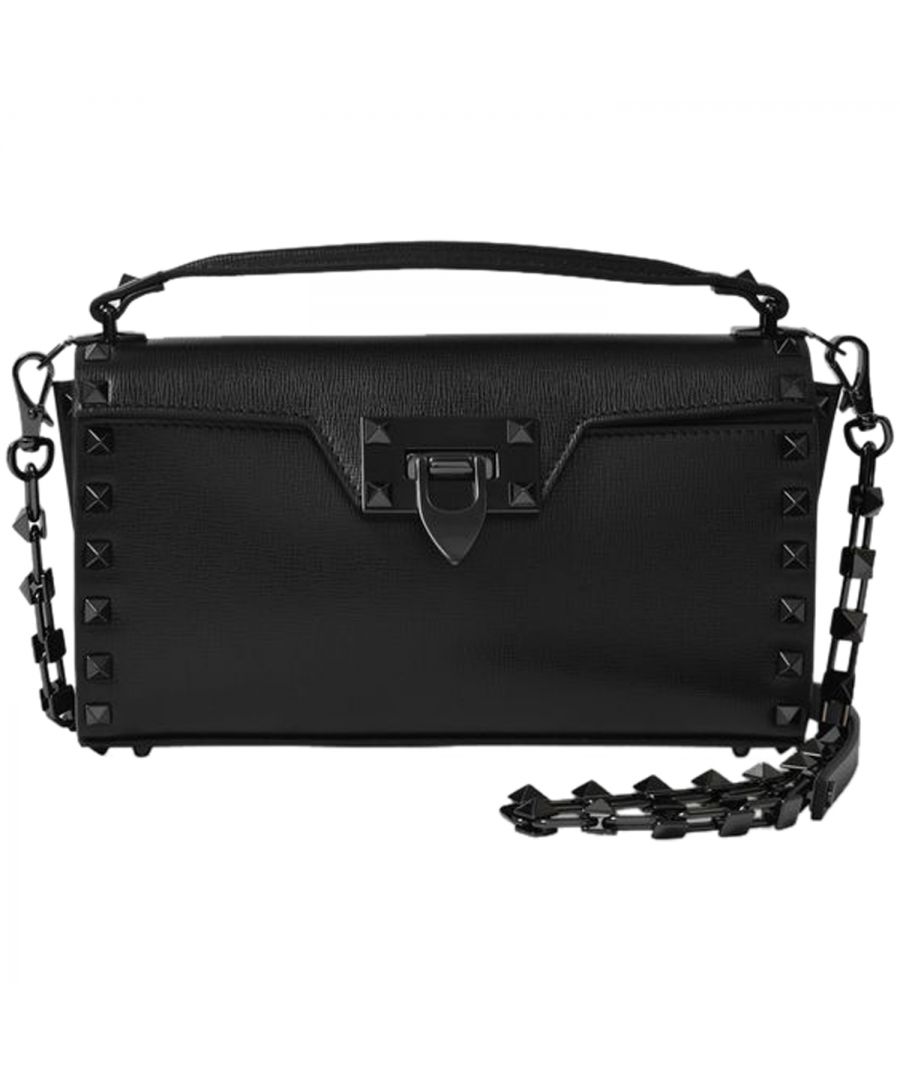 This bag from Valentino Garavani comes with the fashion house's iconic studs that add a chic feel with an edgy twist. Wear it on your shoulder with a silk blouse, jeans and pointed shoes for a seriously elegant look. Top handle : 8 cm - Shoulder strap : 115 cm. Worn two ways - one top handle and one detachable shoulder strap. Material : smooth calfskin. Lining : leather. Colour : Noir - Nero. Closure : ratchet clasp with flap. Interior : one flat pocket.