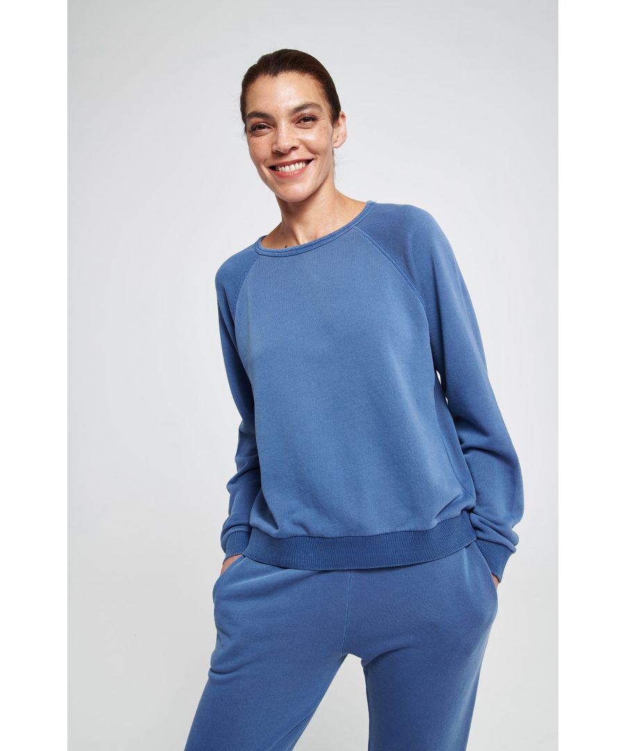 This classic, relaxed fit sweatshirt has raglan sleeves and has been made in our gorgeous, seriously comfy, organic cotton pigment dyed fleece. Throw on over your favourite jeans or legging - perfect for life on and off your mat.\n\n100% Organic Cotton Fleece\nMade with organic cotton, ethically grown, knitted and dyed in Turkey\nGOTS certified grown without chemicals, fertilizers and pesticides\nOeko-Tex certified no nasties in the dyeing process\nBetter for your skin, especially those with allergies or sensitivities\n\nMade in our certified factory in India using a garment dyed technique, which gives every item unique variations in colour and tones. This vintage look will be further enhanced during wear and washing, giving your tracksuit a loved and lived in appearance.