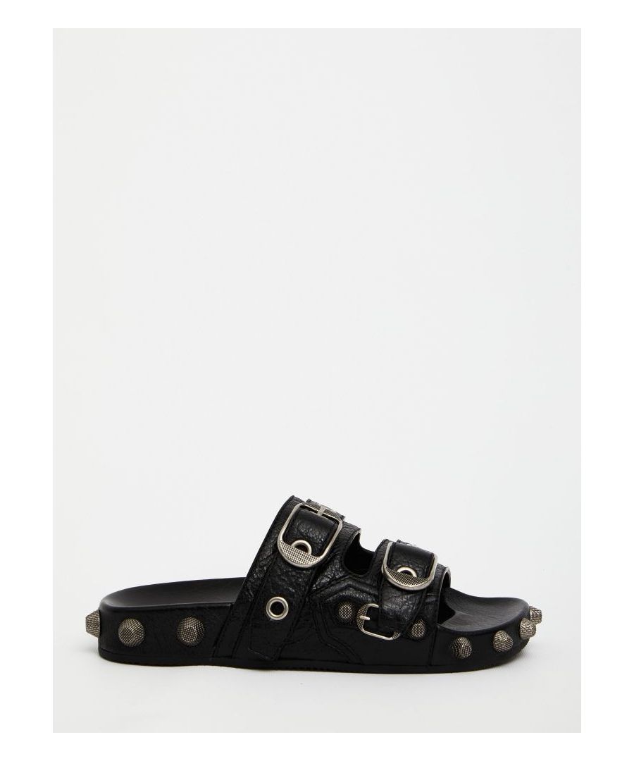 Cagole Slide sandals in black leather with all-over silver-tone studs. They feature round and open toe and band design with adjustable straps.   