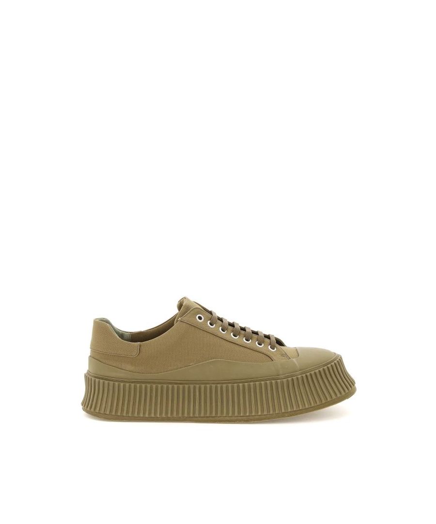 Jil Sander sneakers crafted in cotton canvas with rubber-coated base and toe and characterized by the rubber platform with ribbed sides and vulcanized bottom. Lace-up closure with silver-finished metal eyelets, canvas lining and removable leather insole. 