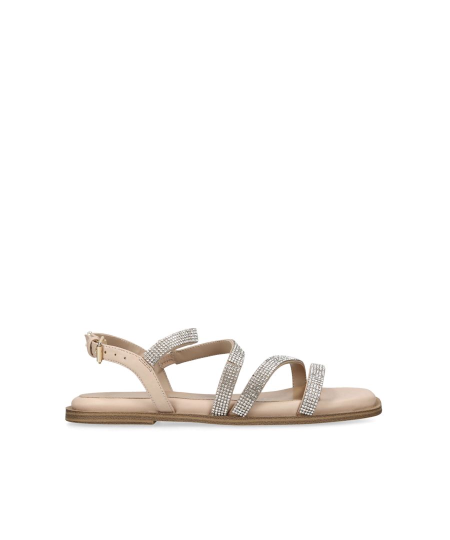 The Roxy is a flat sandal. Each strap is embellished with crystals. The strap is fastened with gold tone buckle and the back of the ankle features a gold tone KG stud. This product is registered with The Vegan Society.