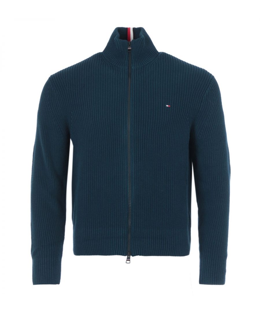 For a seriously cosy feel, this ribbed zip through sweater from Tommy Hilfiger is the perfect piece to refresh your wardrobe with sustainable style. Knitted from pure organic cotton in a relaxed fit. Featuring a funnel neck with a full zip closure, long sleeves and a thick ribbed texture. Finished with the iconic Tommy flag logo embroidered at the chest. Relaxed Fit. Organic Cotton Knit. Thick Ribbed Texture. Funnel Neck Full Zip Closure. Long Sleeves. Tommy Hilfiger Branding. Style & Fit: Relaxed Fit. Fits True to Size. Composition & Care: 100% Organic Cotton. Machine Wash