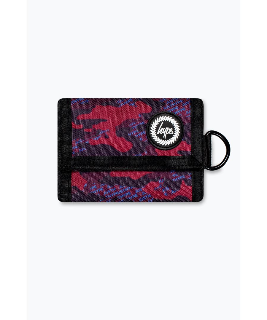 Meet the HYPE. Burgundy & Blue Logo Camo Wallet, part of the HYPE. 2022 Back to School collection. Designed in our unisex wallet shape with an all-over burgundy and blue logo camo print, this is the perfect lightweight holder for all your coins, cash, and cards. With multiple inside compartments to store your everyday essentials and finished with Velcro fastening and the iconic HYPE. rubberised crest. Bundle up with the matching backpack, lunchbox, and water bottle to start the school year in style. Please ensure you wipe clean to keep in pristine condition.