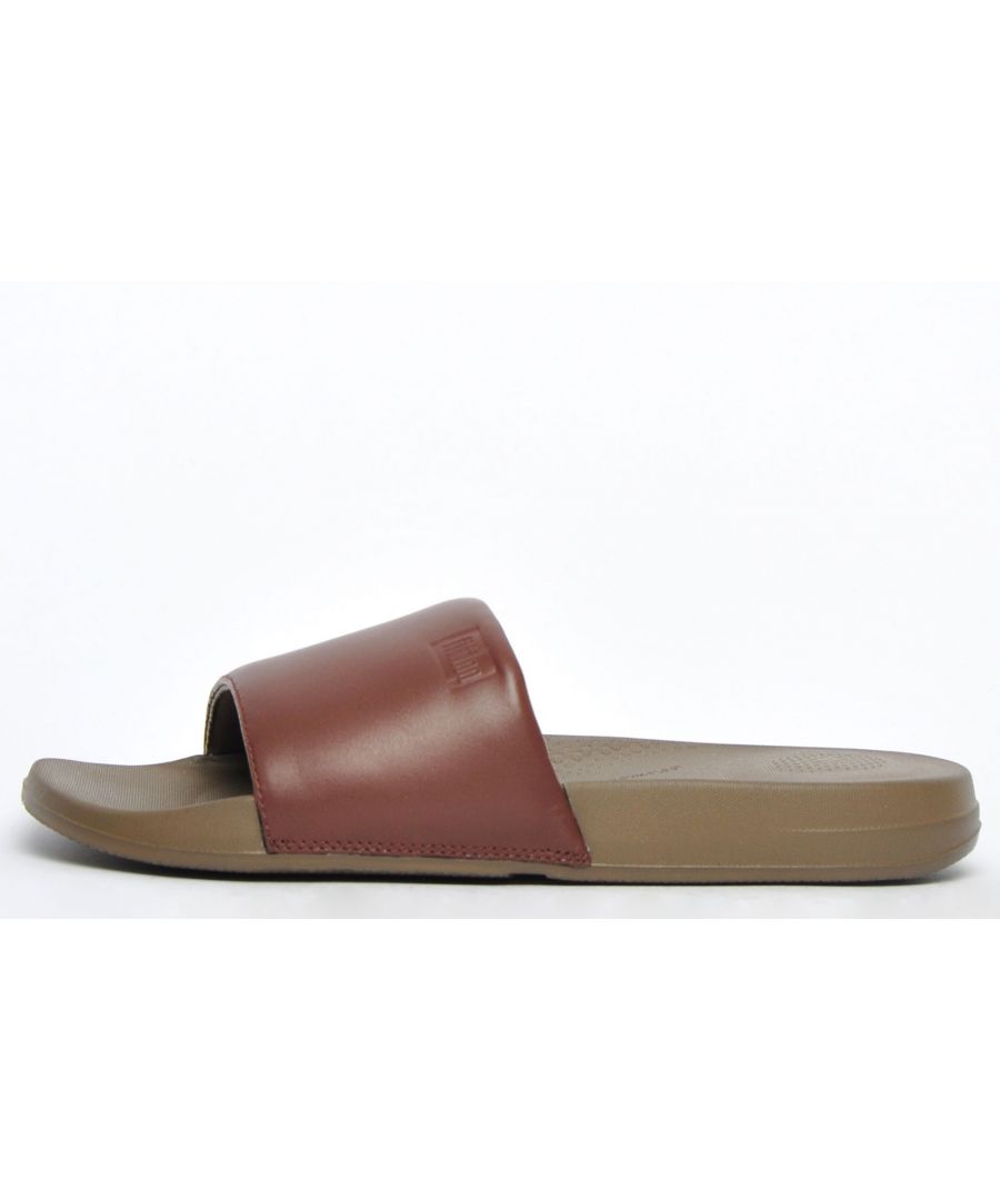 Level up your casual summer wear with these FitFlop iQushion mens slides, boasting a premium leather upper that offers a sophisticated take on the classic slide silhouette. These iQushion mens slides feature exclusive iQushion midsole technology to deliver an ergonomically shaped footbed with high-rebound, air-foam cushioning to provide natural arch support and shock absorption. The leather foot strap in an on-trend brown colourway provides a stylishly sophisticated look whilst keeping feet secure. Look no further for a practical and comfortable choice in womens slides, FitFlop has you covered!\n - Leather upper\n - Slip on design\n - iQushion midsole for enhanced comfort\n - Ergonomic foot arch for support\n - Rubber outsole for traction\n - FitFlop branding