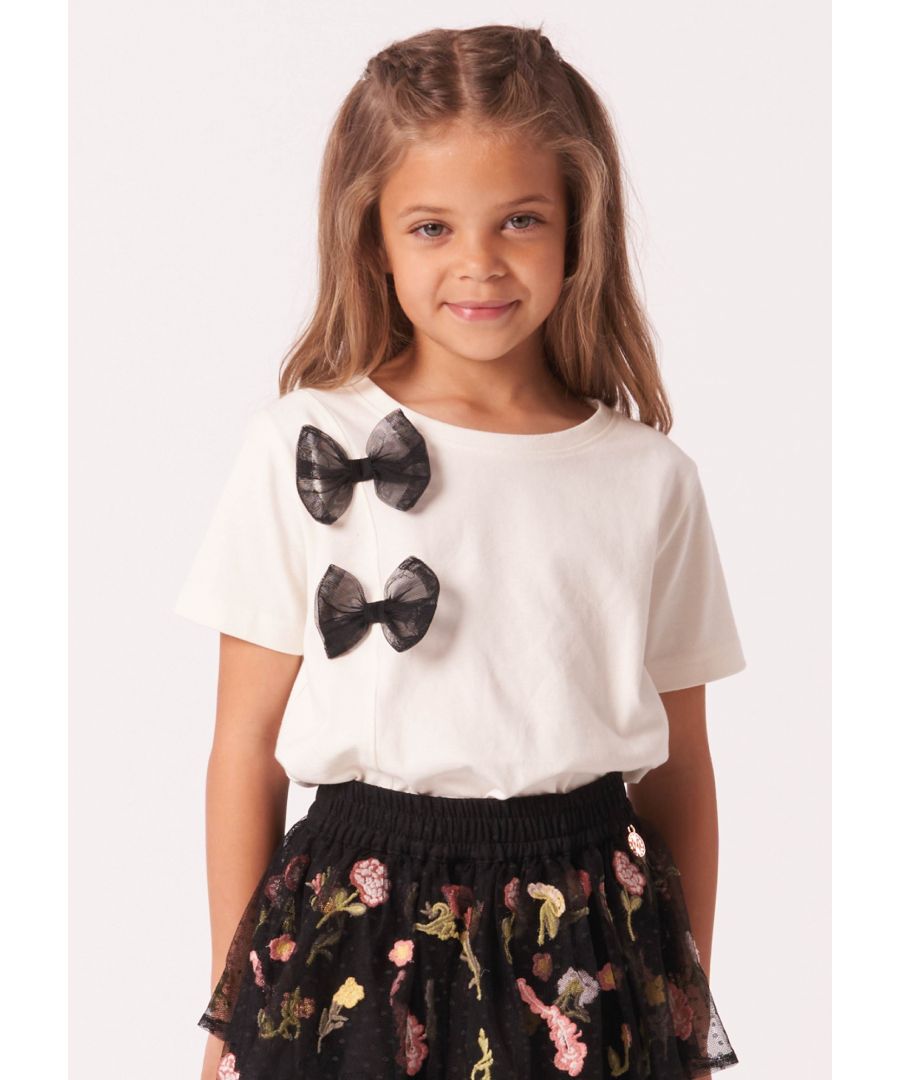 The cutest tee you ever did see. Super soft cotton in versatile   with contrast black mesh bows. Wear with our embroidered mesh skirt for the ultimate outfit .  . About me: 100% Cotton exc trims. Look after me: Think planet. wash at 30c.