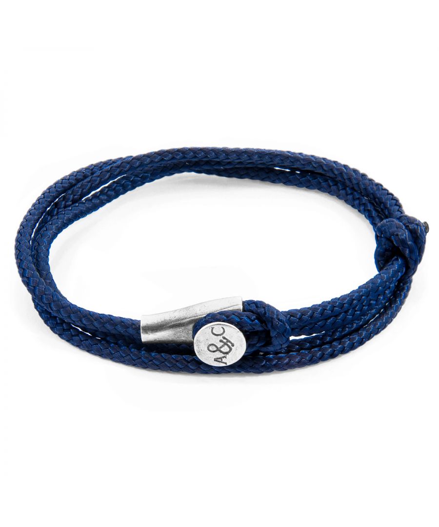 The Navy Blue Dundee Silver and Rope Bracelet was both designed and skilfully handcrafted completely in Great Britain, In Quality We Trust. For the Modern Journeyman (and woman), ANCHOR & CREW takes ownership of an exploratory lifestyle and enjoys the Happy-Good Life. Combining British craft manufacturing with a discerning modern-minimalist style, this ANCHOR & CREW bracelet features: \n\n3mm diameter performance Marine Grade polyester and nylon rope (GB) \nSecure solid .925 sterling silver mushroom-button cleat (GB)\n\nSIZING\nThis bracelet is one size fits all, with the rope able to extend or tighten to suit your wrist size. To take the bracelet on or off your wrist, simply slide the one adjustable knot around the rope to make the loop size smaller or larger, and once set, keep the loop size consistent and continue wearing by easily unhooking the loop over the clasp. As pictured, the bracelet is most secure when the rope loop is fed through the smaller loop that emerges beyond the clasp.