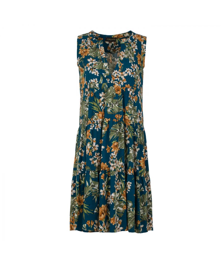 This floral dress with gathered seams is crafted in allover print woven viscose fabric with a blue background. It is sleeveless and has a round neckline with a 24cm V opening in the front. There is a press stud on the inside at the bottom of the V to prevent it opening too much. There is oblong shaped double fabric below the V opening in the front. The dress has two 24cm wide ruched panels. There is a double pleat in the back. The dress is styled in a loose A line silhouette and it hits above the knee.