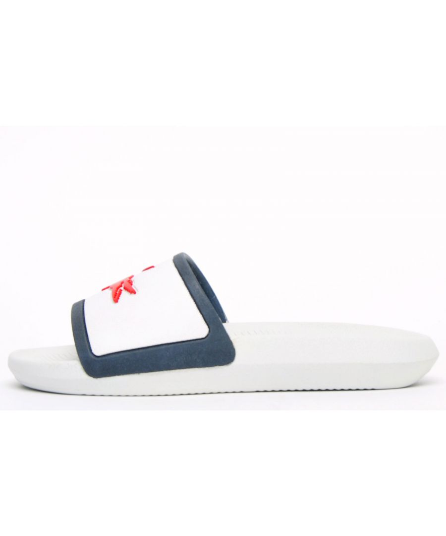 Get laid back wear and chic style with these Lacoste Croco Slides. These on-trend white, navy and red slider sandals are crafted with comfort in mind. The sandal also has a comfort fit wide strap and a great water resistant super comfy footbed for a great fit and feel for the pool side and everyday wear. \n - Comfort fit strap \n - Durable rubber sole\n - Luxurious cushioned footbed \n - Lacoste branding throughout\n Please Note These Lacoste Slides are being sold at a reduced price as they may have minor imperfections which could be any or none of the following; shading issues, small glue marks, dirty marks consistent with the shoes being handled. These are only cosmetic issues and will not affect the overall performance of the slides and after a few wears any marks may become less noticeable. However, if you are unhappy with your purchase we will be more than happy to take the shoes back from you and issue a full refund.