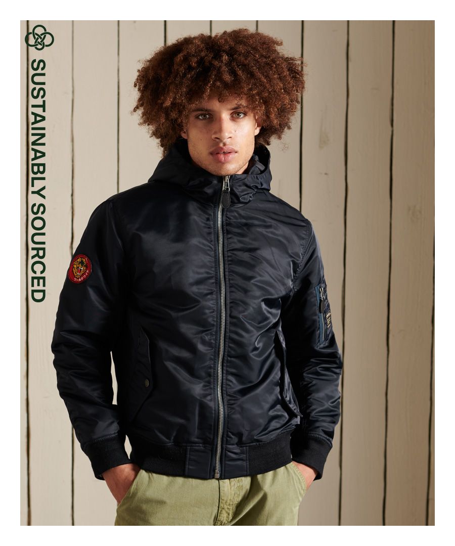 For an updated version of our classic MA1 Jacket, the MA1 Hooded Bomber Jacket features unique patches, three external pockets, and a quilted lining.Relaxed fit – the classic Superdry fit. Not too slim, not too loose, just right. Go for your normal sizeRecycled PaddingHoodedZip fasteningThree pocketsSingle internal pocketRibbed cuffs and hemQuilted liningSignature logo patchesThe padding in this jacket is 100% recycled, each jacket contains up to 30 recycled bottles, this avoids these bottles being sent to landfill or polluting our oceans.