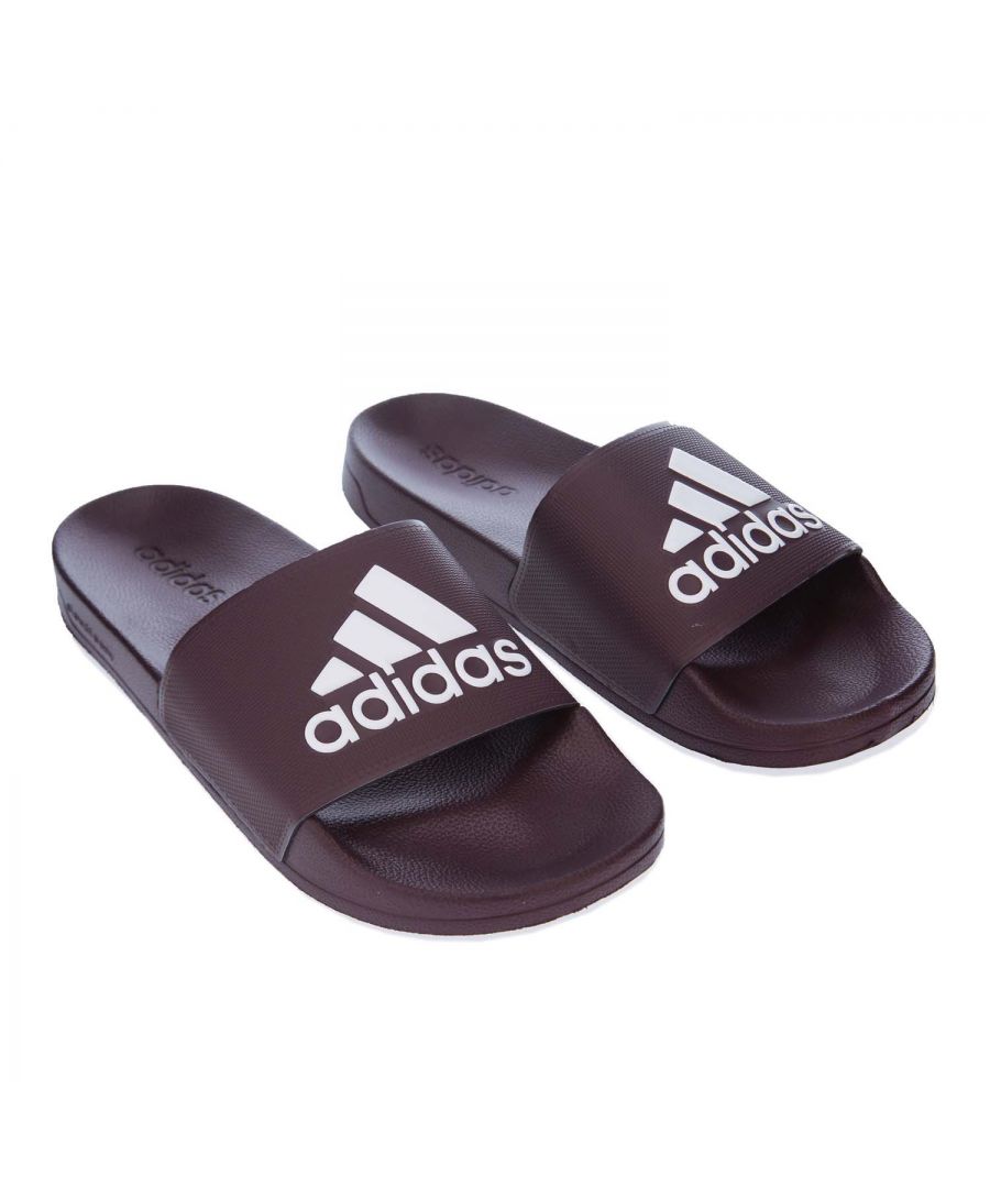 Mens adidas Adilette Shower Slide Sandals in burgundy.- Single-bandage synthetic upper.- Slip-on construction.- Soft and quick drying. - Lightweight feel. - Contoured Cloudfoam footbed. - Contrast adidas Badge of Sport logo.- EVA outsole. - Synthetic Upper  Synthetic Lining  Synthetic Sole.- Ref.: EE7042