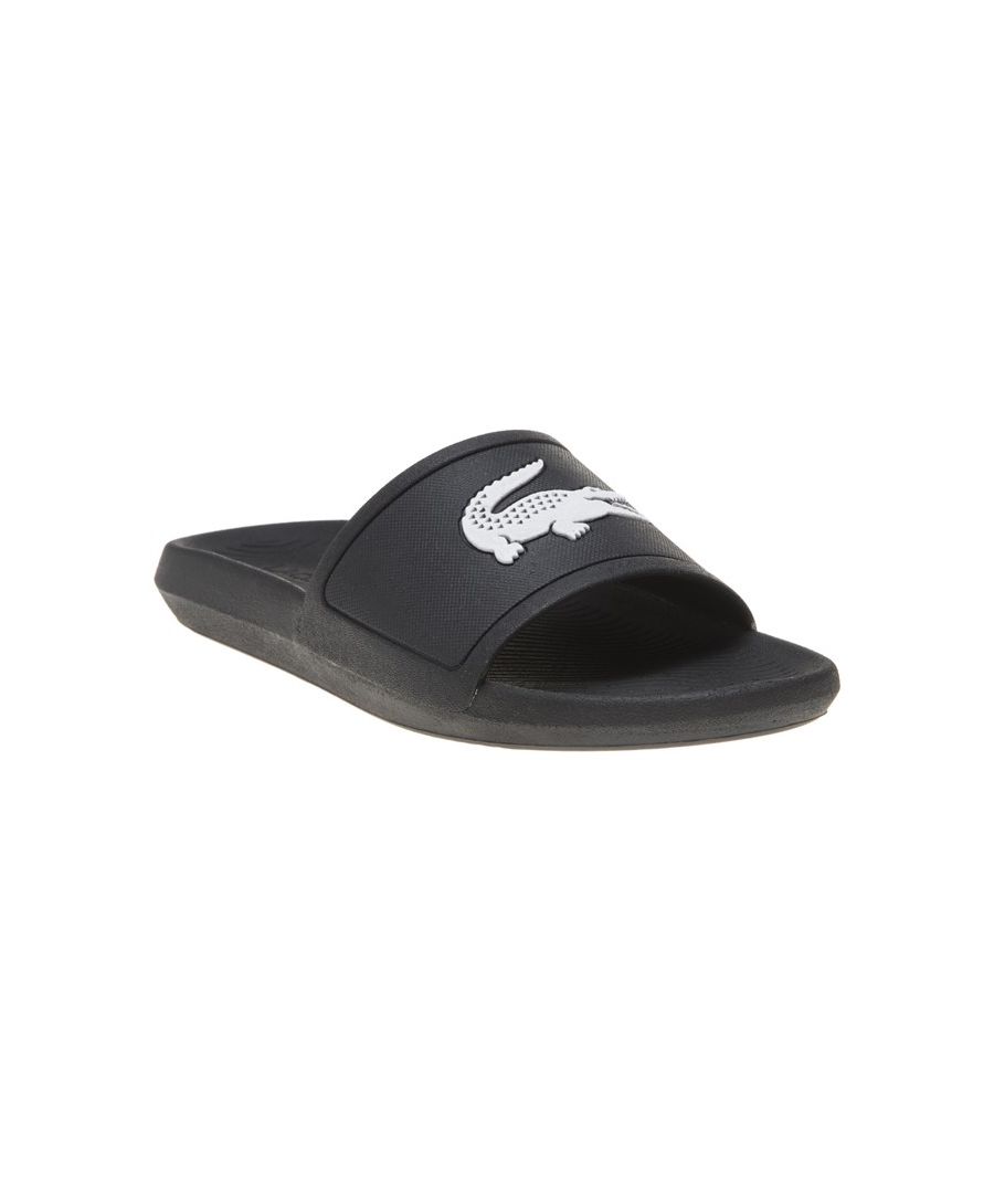 Head to the beach in style with these mens Lacoste Croco Slides. These on-trend sandals are crafted with comfort in mind whilst boasting a great water resistant super comfy footbed for a great fit and feel for the pool side and everyday wear. These designer slides are finished with eye catching Lacoste branding throughout just in case you want a sign of approval that youre wearing cool chic style this summer season\n \n - On trend synthetic upper\n - Comfort moulded footbed\n - Grippy outsole\n - Slip on wear\n - Iconic Lacoste branding throughout\n Please Note: These slides are supplied poly bagged (without box)\n These Lacoste Slides are sold as B grades which means there may be some very slight cosmetic issues on the shoe and they come in a poly bag. There could be occasional issues with wrong swing tags being allocated to wrong shoes by Lacoste themselves which could result in some size confusion but you must take the size IN THE SHOE as the size that the shoe actually is ( not what is on the tag ). We have checked most of the shoes and in our opinion,all are practically perfect without any blemishes on them at all and in essence if the shoes did not have the letter B denoted on the swing tag you would presume these were perfect shoes. All shoes are guaranteed against fair wear and tear and offer a substantial saving against the normal high street price. The overall function or performance of the shoe will not be affected by any minor cosmetic issues. B Grades are original authentic products released by the brand manufacturer with their approval at greatly reduced prices. If you are unhappy with your purchase, we will be more than happy to take the shoes back from you and issue a full refund