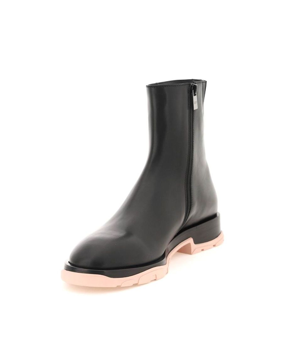 Slim Tread ankle boots by Alexander McQueen crafted in smooth leather with zip closure and small concealed elastic insert on the inner side. Leather lining, leather sole with squared heel and contrasting rubber-coated bottom with engraved logo on the back. 